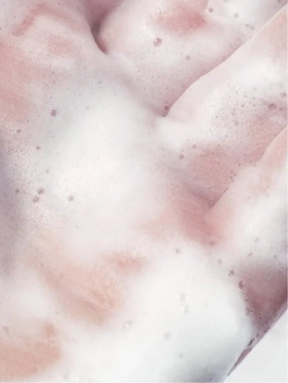 Close-up of foamy texture in a hand, showcasing a purifying toner for skincare.